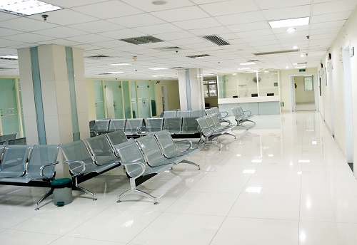 Image of a well-lit hospital waiting room with no people.